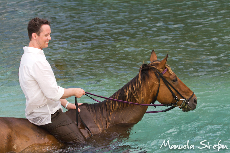 Groom riding horse in Jamaica